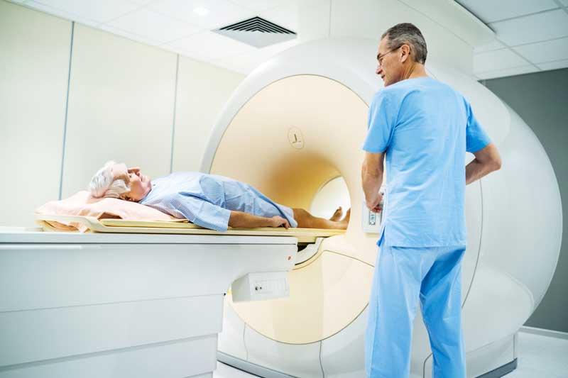 man going into MRI